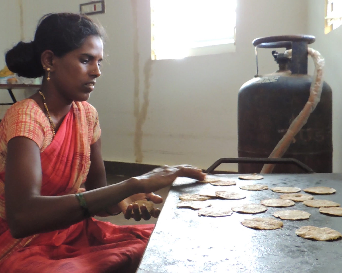 Roasting millet crispies using cleaner-burning liquefied petroleum gas (LPG)
