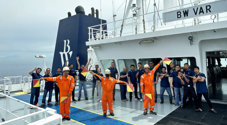 Crew onboard BW Var sending a message using semaphore flags.